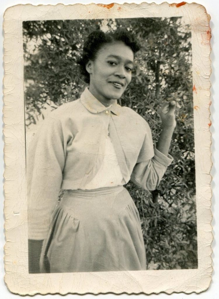 1950s vintage photo of a young Black Women at Jackson College posing for a photo in her Bolero Cardigan and skirt. 