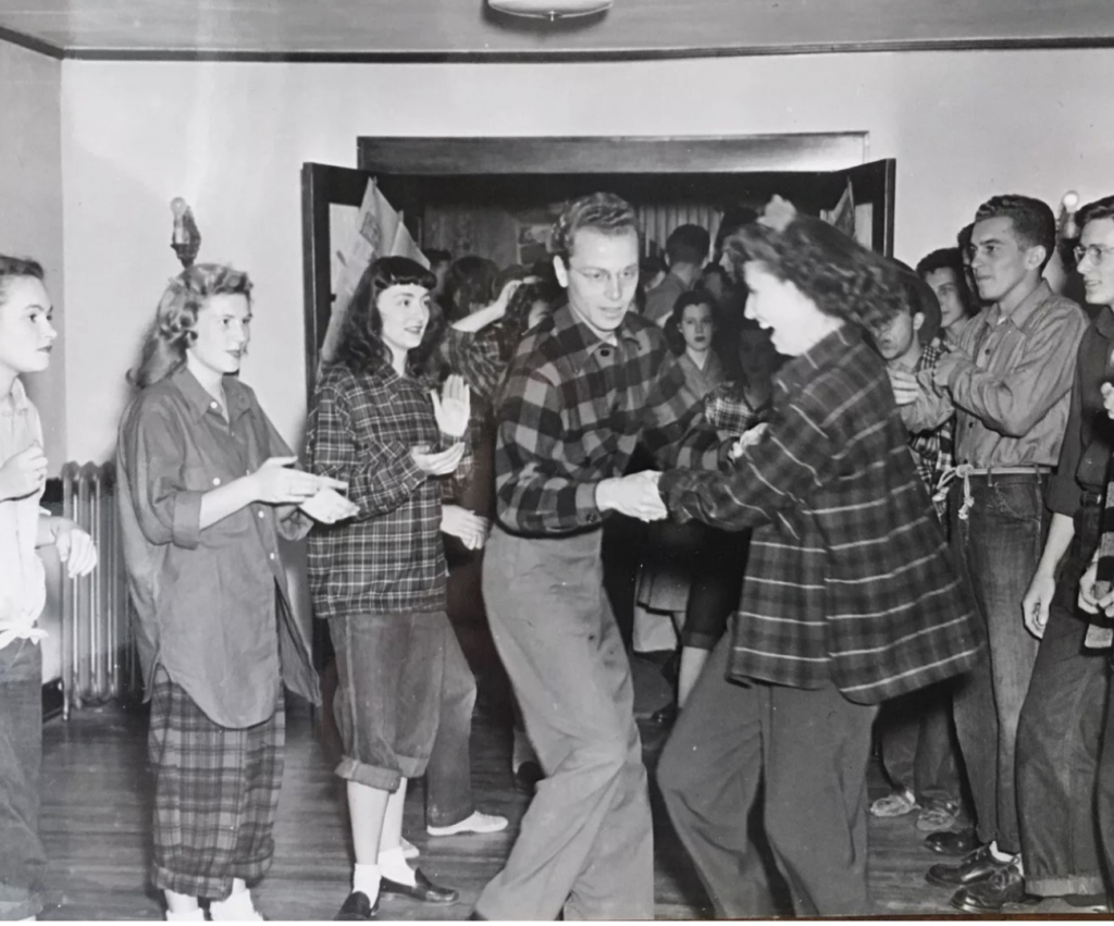 1940s Vintage Photo of college students swing dancing (Lindy Hop / Jitterbug) in plaid fashions. Fantastic 1940s Hairstyles for Women and 1940s fashions. 