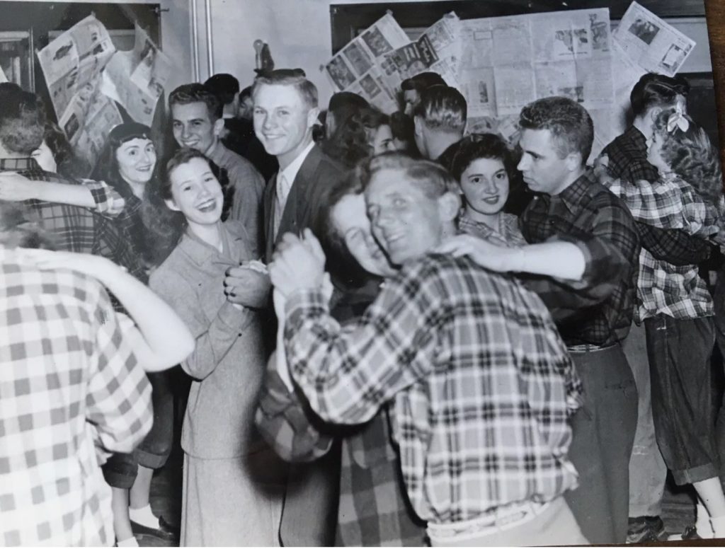 1940s Vintage Photo of college students swing dancing (Lindy Hop / Jitterbug) in plaid fashions. Fantastic 1940s Hairstyles for Women and 1940s fashions. 