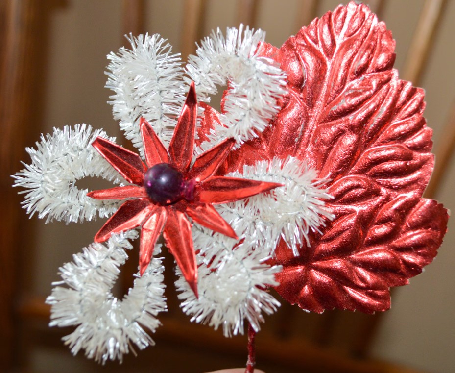 1950s vintage Christmas brooch featuring an unusual white chenille poinsettia flower with a red foil center and purple mercury glass bead & a red foil leaf at the back. 