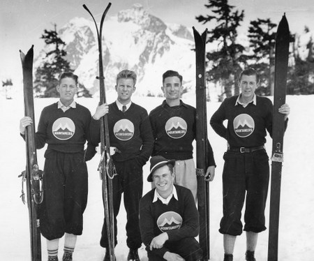 1930s vintage photo of a men's ski team in their matching sweaters, ski pants and skis. 1930s Ski Fashion. 