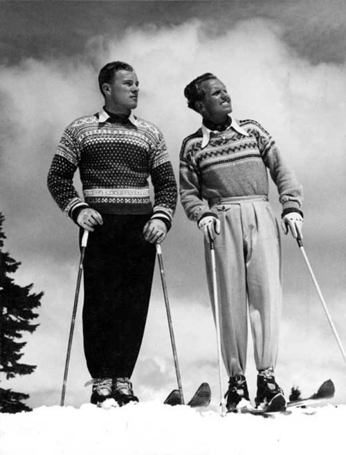 1940s vintage photo of men in 1940s ski wear posing at the top of a mountain in their 1940s sweaters